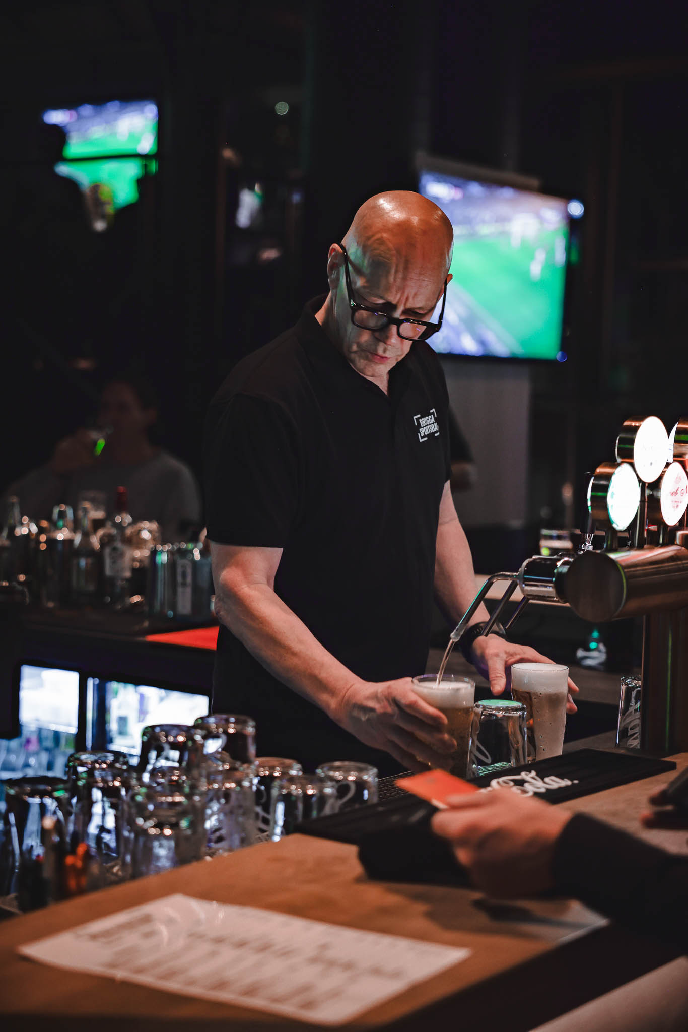 Brygga Sportsbar bartender som sjenker drikke